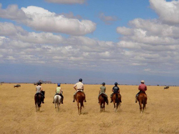 "Horseback Riders at Chyulu Hills National Park"