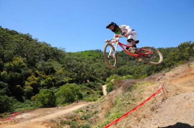 "Mountain biker jumping in the air"