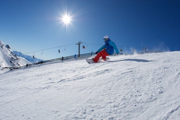 "Snowboarder sliding on the snow"