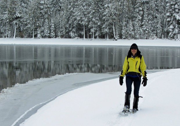"Snowshoeing next to a frozen lake"