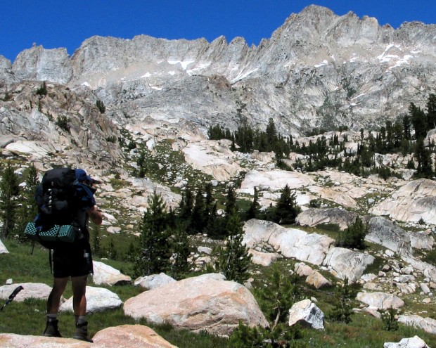 "A lonely backpacker walks through the wonderful vistas at Yosemite National Park"