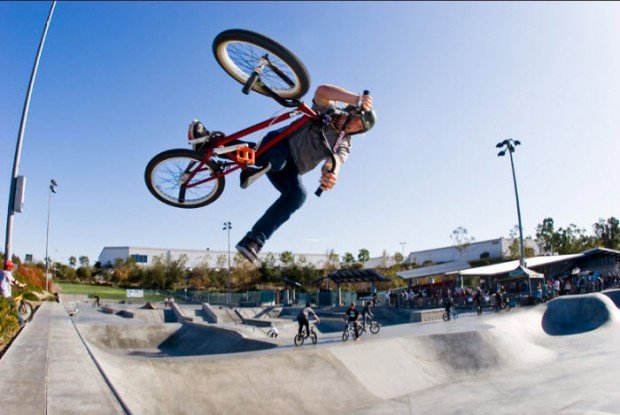 "BMX Rider Jumping high at a skatepark"