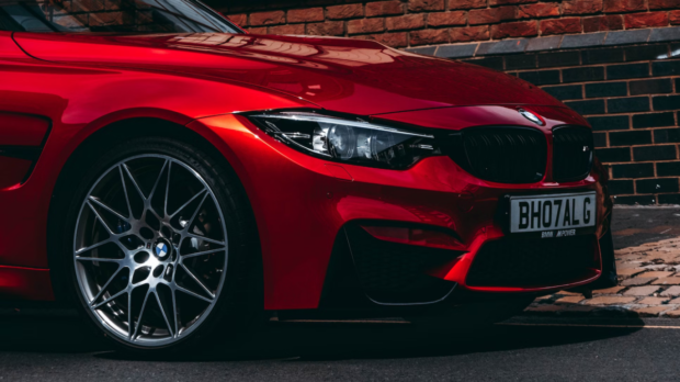 Image source: https://unsplash.com/photos/red-bmw-vehicle-park-on-road-aoGG6Vbdonc